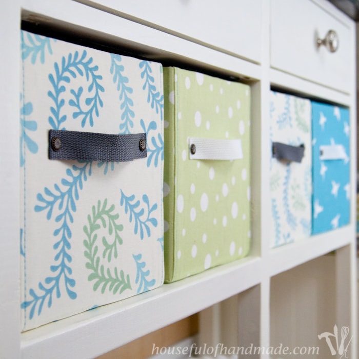  Easy DIY fabric storage boxes four shown on book case. 