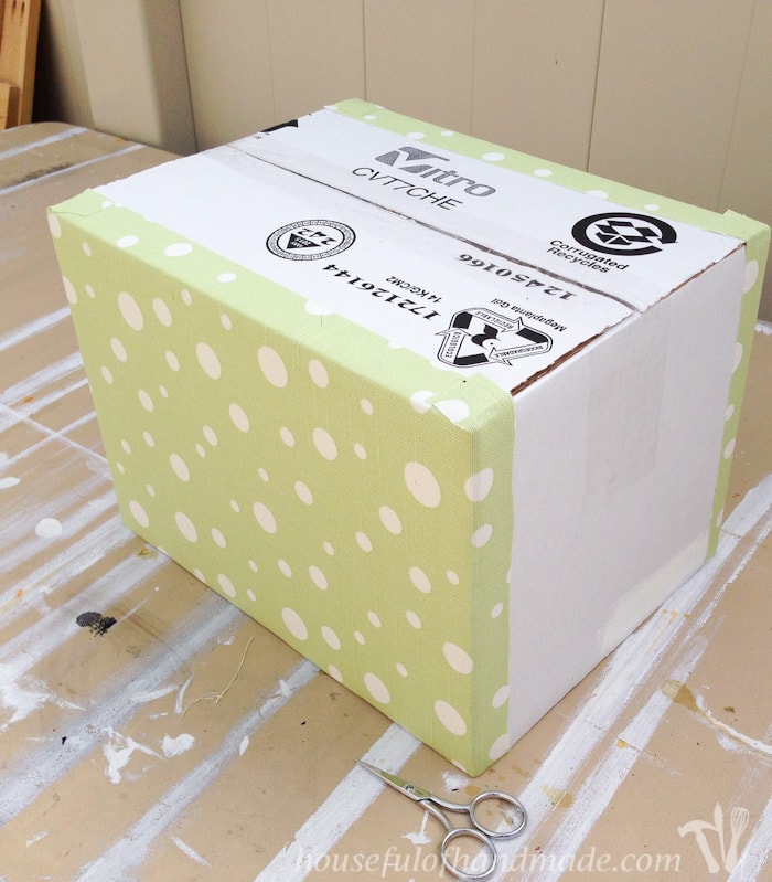 cardboard box shown with fabric on two sides