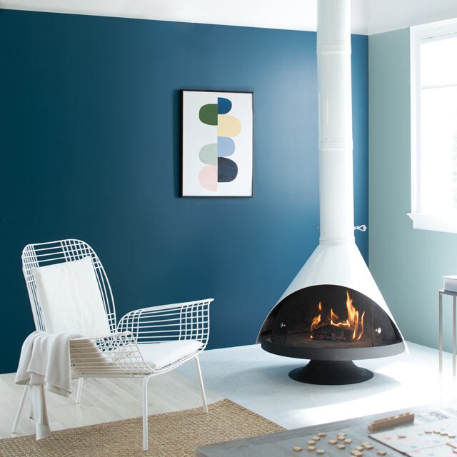 A cozy living room complete with a retro fireplace accompanied by blue painted walls