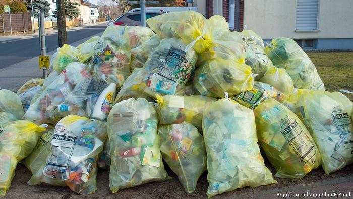 Plastic waste piled up in yellow bags.