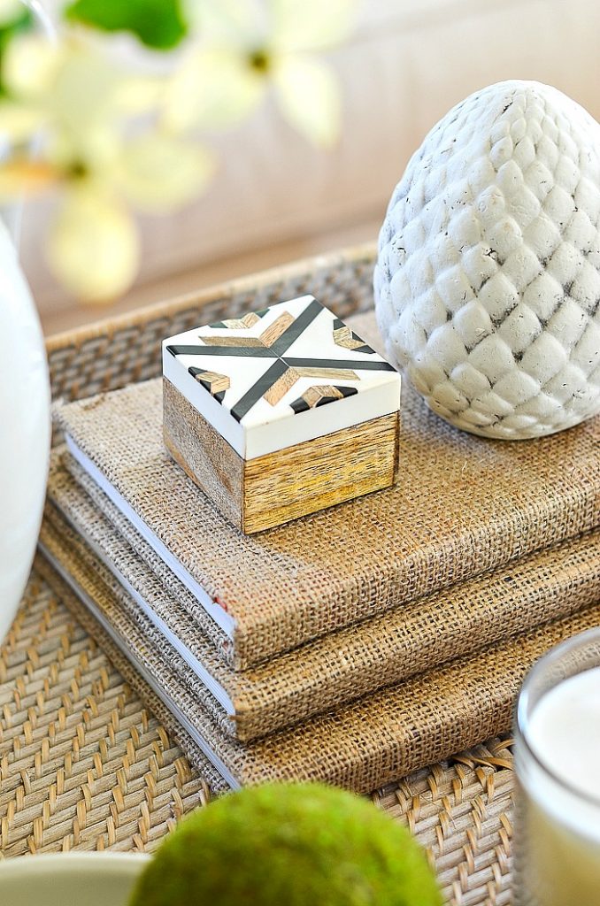 coffee table accessories, little box on a stack of burlap covered books